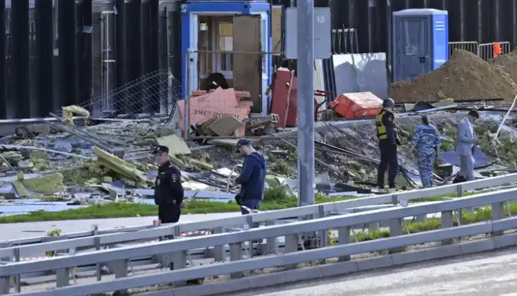 Investigators examine a damaged building after a reported drone attack in Moscow, Russia, Monday, July 24, 2023. (