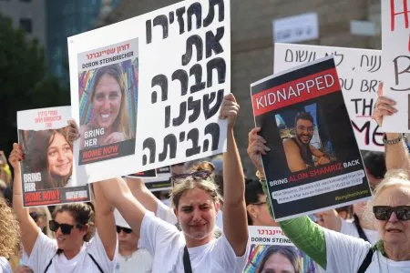 Protesters hold placards and portraits of Israeli hostages held by Hamas militants during a demonstration calling for their release in Tel Aviv on October 26, 2023. More than 200 people are thought to have been kidnapped by Hamas. GETTY