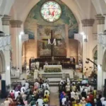 Worshippers are seen in a Catholic church, Holy Saturday