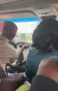 FRSC Official Seen Dragging Steering Wheel Of Moving Car With Woman In Abuja (Video)